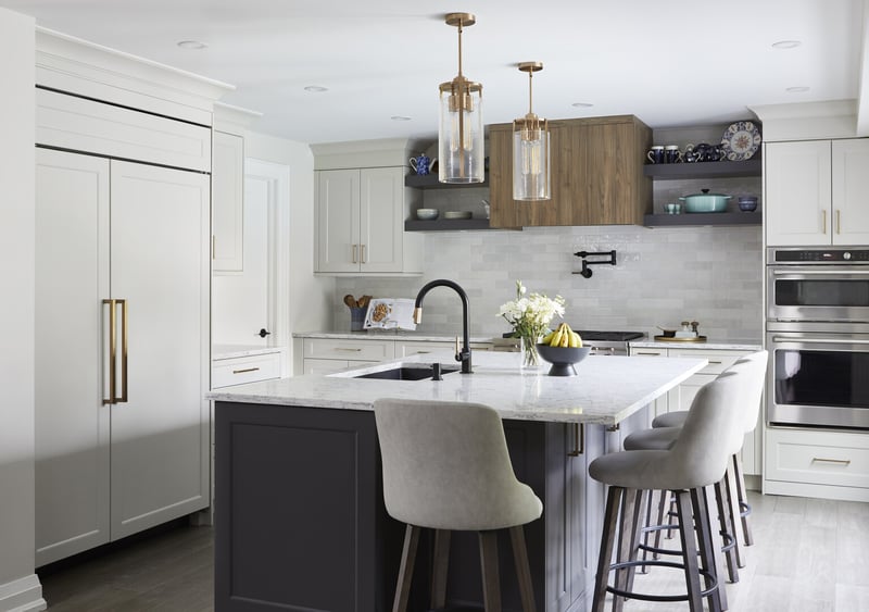 Kitchen with white cabinetry and island by Master Edge Homes