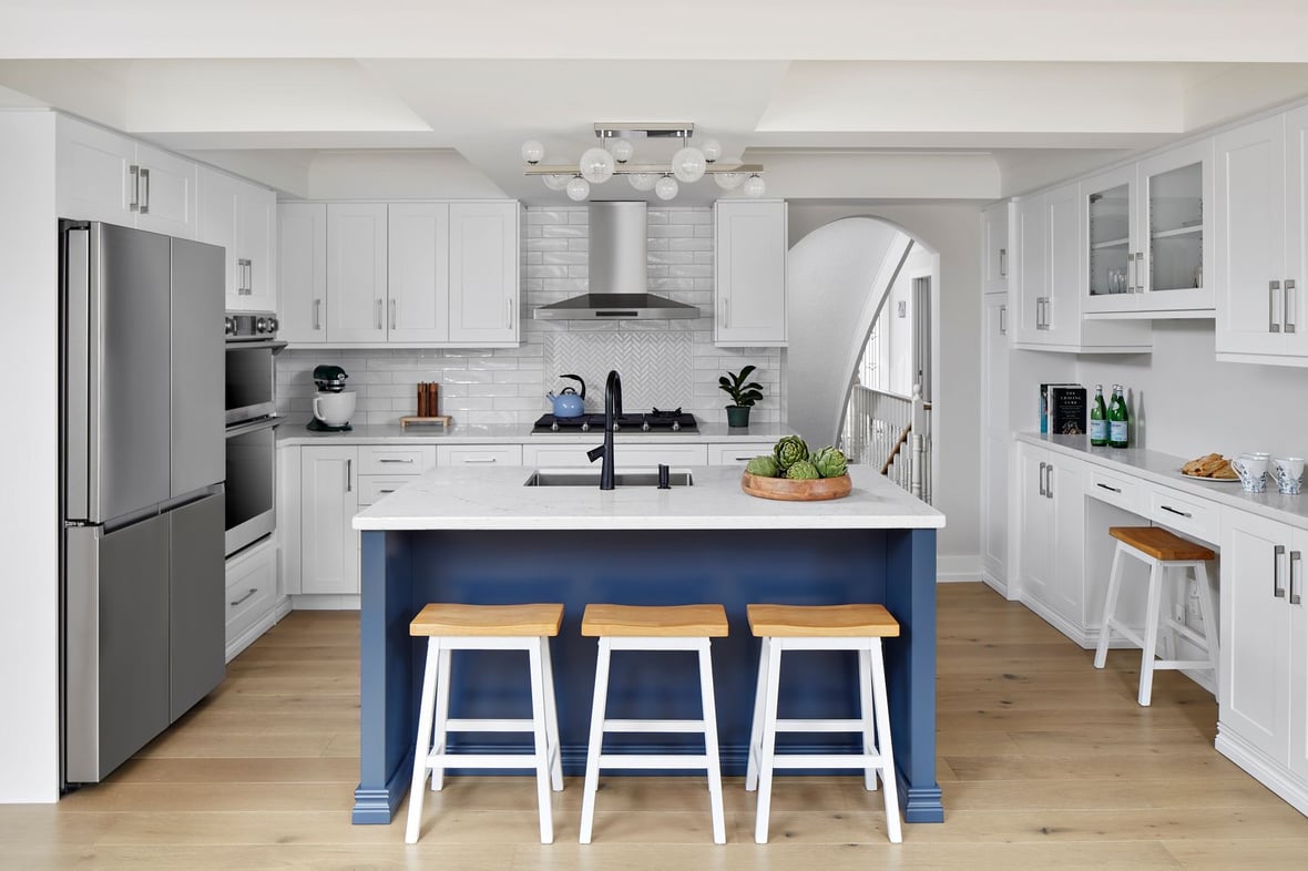 White modern kitchen with herringbone style backsplash blue island and barstools in Markham renovation